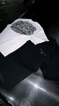 White graphic T-shirt with bold black lettering displayed alongside a black shirt