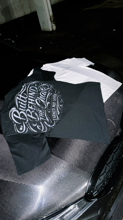 Graphic T-shirt with Built Behind the Chair and Earned Not Given lettering
