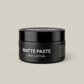 Black matte paste jar on a light studio background