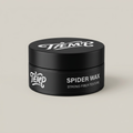 Black Spider Wax jar on a light studio background